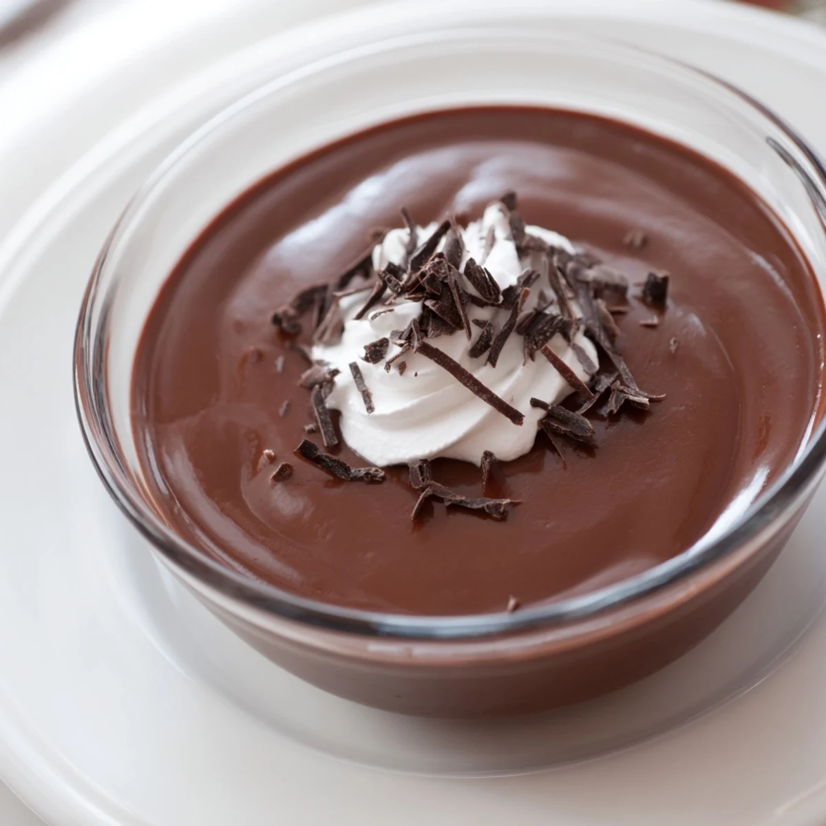 Silky smooth chocolate pudding served chilled, an elegant dessert in individual glasses.