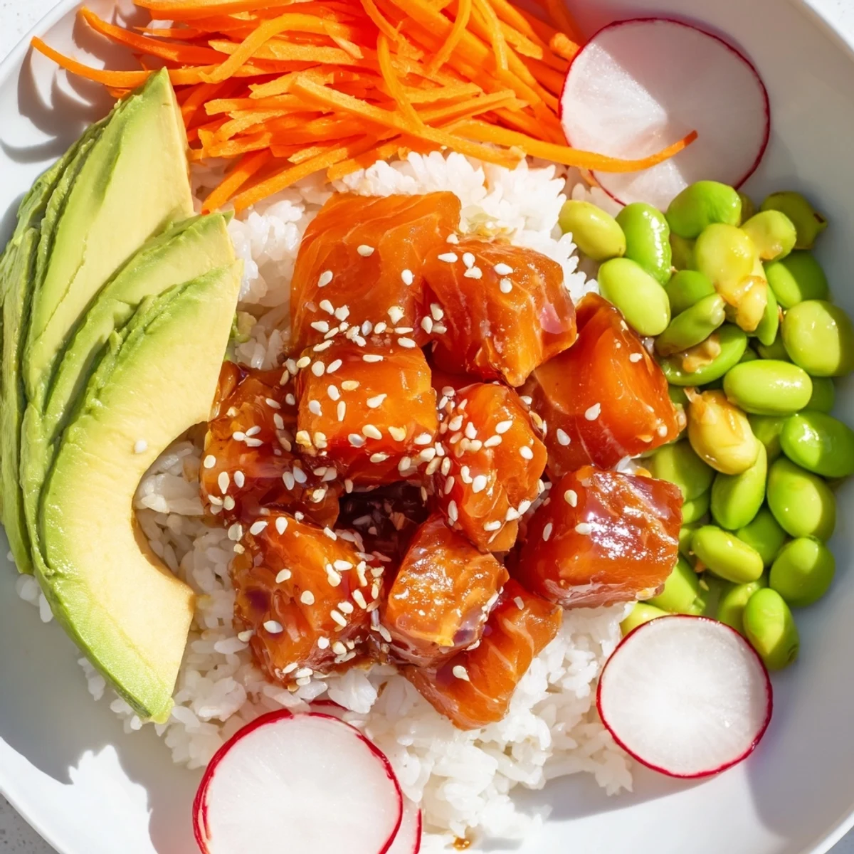 A perfect pescatarian meal: Homemade poke bowl with soy sauce and sesame seed garnish.