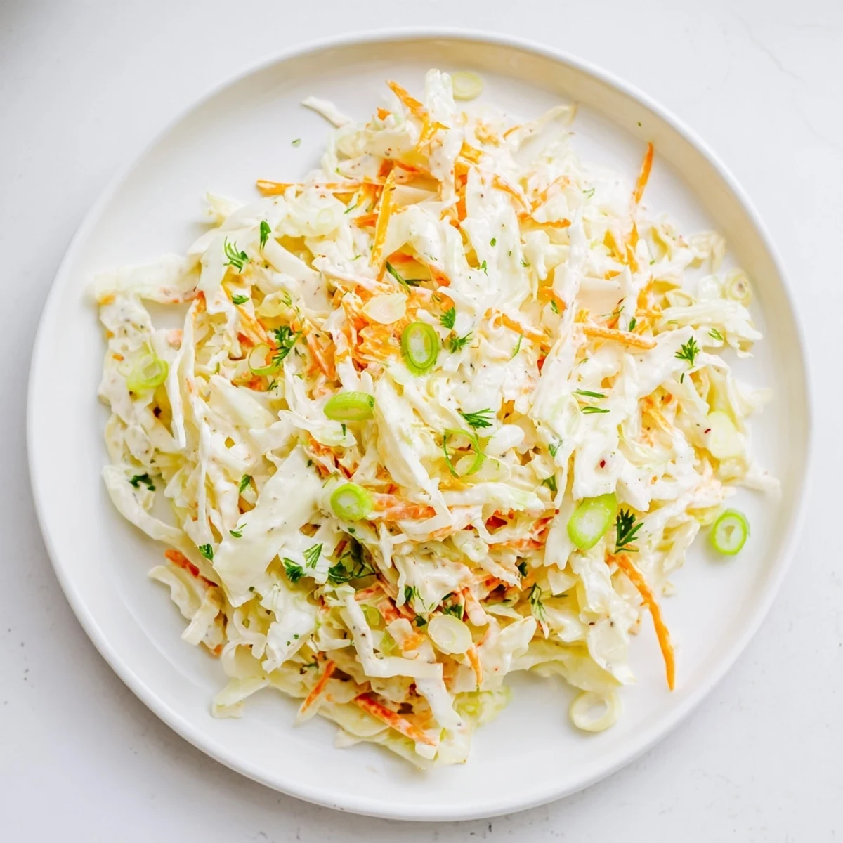 Cool and creamy coleslaw with apple, with crisp green cabbage and sweet, juicy apple bits.