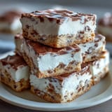 Decadent clotted cream cookie bars with white chocolate chunks, golden and gooey, perfect for a cozy British-inspired treat.  