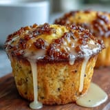 Bright lemon poppy seed muffins with golden tops, topped with a tangy citrus glaze for a perfect spring brunch treat.