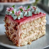 Layered vanilla cake with silky pink ombre buttercream and edible flowers, perfect for Mothers Day celebrations.