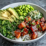 Fresh Salmon Poke Bowl piled high with vibrant avocado and edamame.