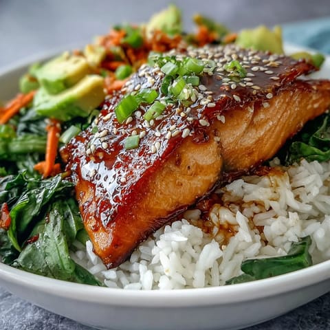 Flaky soy ginger salmon glazed and nestled over steamed rice with crisp Asian vegetables.  