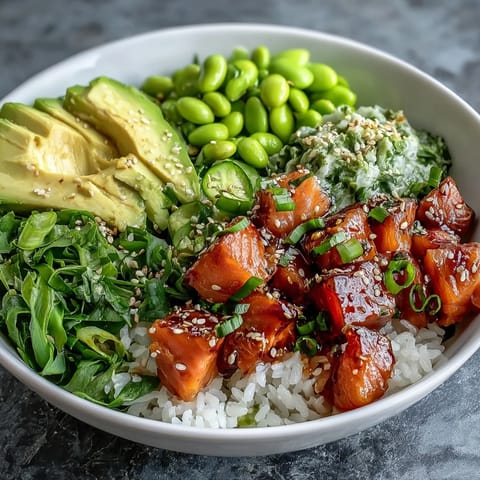 Fresh Salmon Poke Bowl piled high with vibrant avocado and edamame.