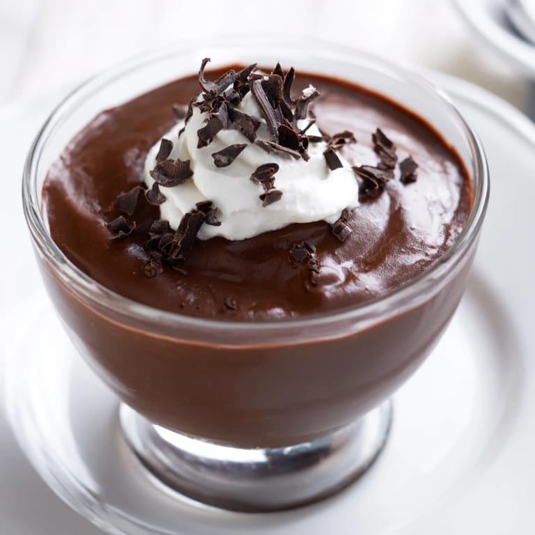Rich, homemade chocolate pudding with a vibrant, glossy finish; imagine the flavor!