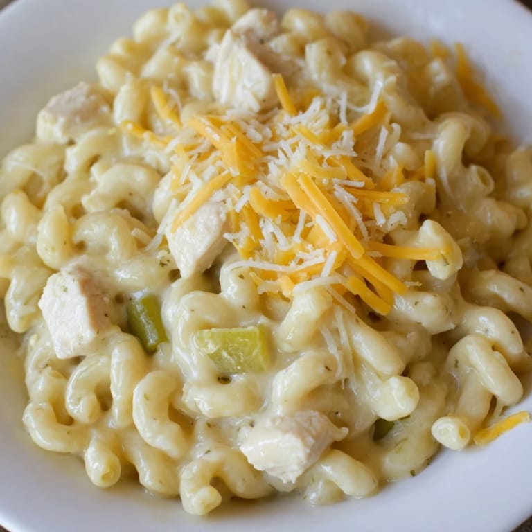 Golden macaroni shells cradle tender diced chicken and mild diced green chiles, coated in a velvety, warm cheese sauce.