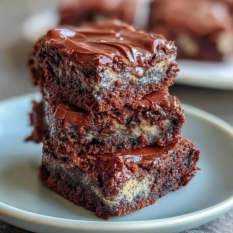 Decadent black sesame brownie squares, marbled with sesame paste and dark chocolate for a unique, indulgent dessert experience.  